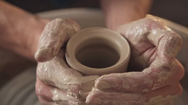 Work in the pottery workshop: clay ware on the potters wheel Stock Image