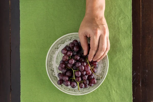 top view of hand picked grape in dish on the table