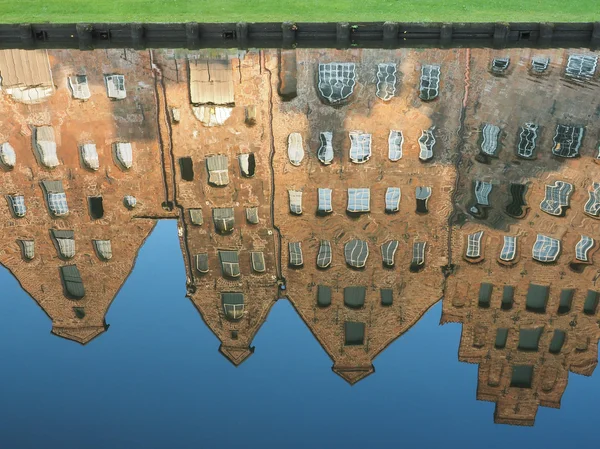 Mirroring of the salt storages of Luebeck, Germany, in water — Stock Photo, Image