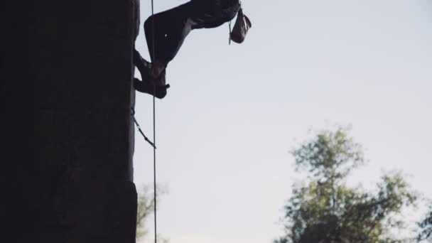 Strong topless climber ascending wall — ストック動画