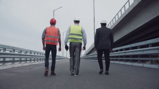 Construction engineers walking up a highway ramp — Stock Video