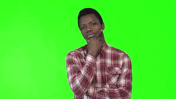Young thoughtful man on chromakey background — Stock Video