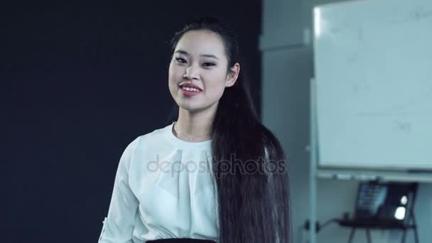 Asian woman sipping tea in conference room — Stock Video