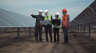 Group of engineers or technicians on a solar farm clipart