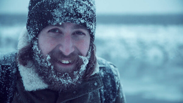 Smiling man with beard in snow