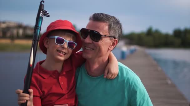 Happy man with son on pier — Stock Video