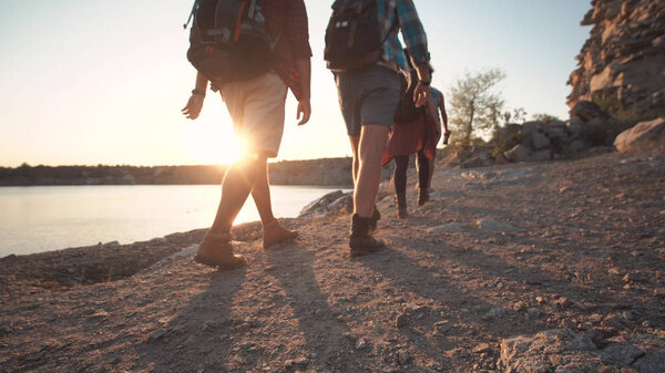 Group of friends hiking on rocky coastline