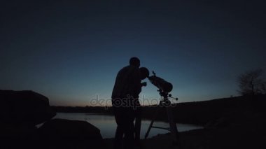Adam ve çocuk teleskop kullanma