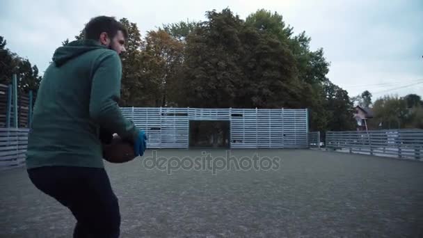 Двое мужчин тренируются передавать мяч по полю — стоковое видео