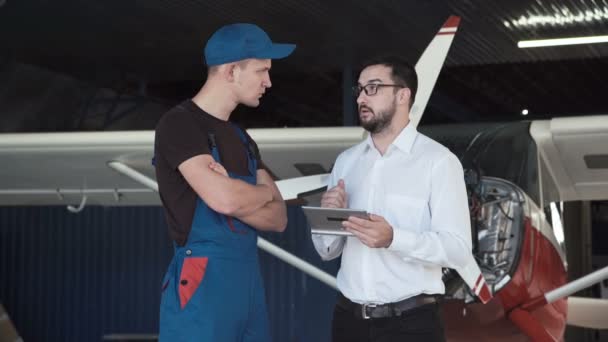 Mechanic and flight engineer having a discussion — Stock Video