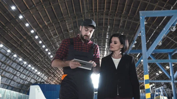 Flight mechanic checking something on a tablet-pc