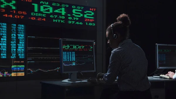Woman stock broker working in futuristic office