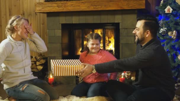 Young family giving each other Christmas gifts — Stock Video