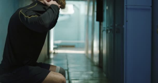 Sportler zieht sich in Umkleidekabine aus — Stockvideo