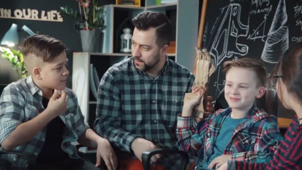 Man dengan anak-anak menjelajahi tangan kartboard mekanis — Stok Video