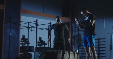 Adam büyük lastik crossfit oturumu sırasında egzersiz