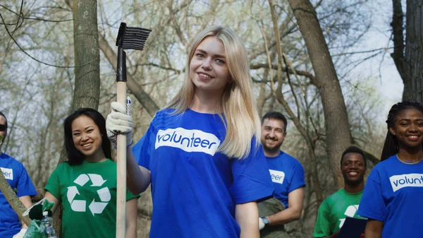 Smiling girl with group of volunteers