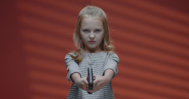 Girl aiming handgun at camera — ストック動画