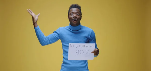 Young man holding sign — Stock Photo, Image