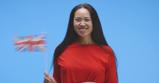 Jeune femme agitant le drapeau britannique — Video