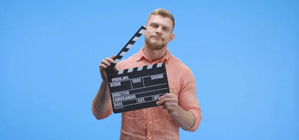 Bored man holding clapperboard — 스톡 사진