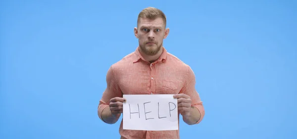 Άνθρωπος κρατάει πινακίδα βοήθεια — Φωτογραφία Αρχείου