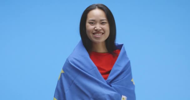 Молодая женщина, завернутая и танцующая под флагом ЕС — стоковое видео