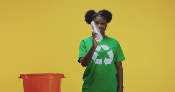 Ung kvinna kasta plastflaska i thrash burk — Stockvideo
