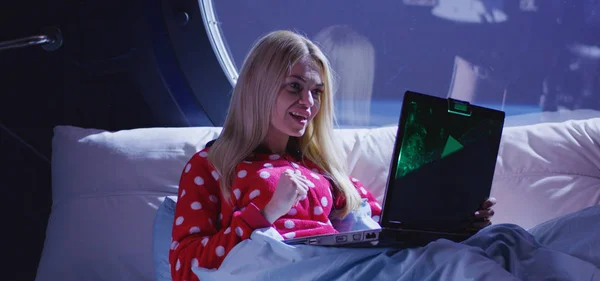 Woman using laptop in a spaceship — Stock Photo, Image