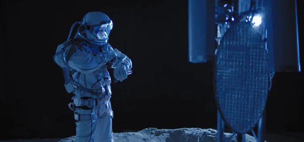 Astronaut checking equipment on Moon — 스톡 사진