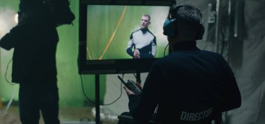 Director giving instructions and watching the scene on monitor