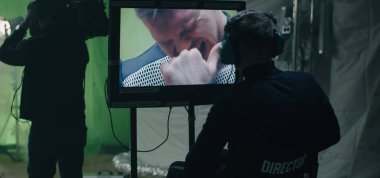 Director giving instructions and watching the scene on monitor