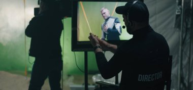 Director giving instructions and watching the scene on monitor