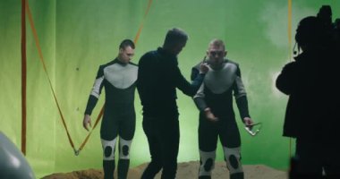 Director watching a shooting and discussing with an actor