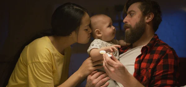 Parents leaving their baby with a babysitter — 스톡 사진