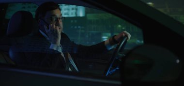 Man answering phone call while driving