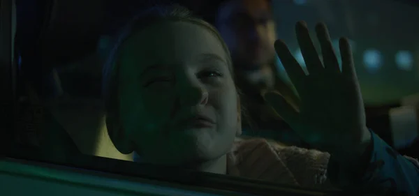Girl pushing face against car window — Stockfoto