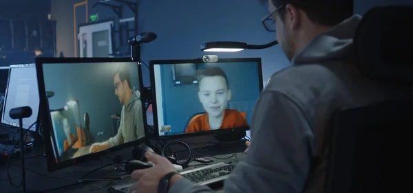 Programmer talking with a boy via a VoIP call — Stock Photo, Image