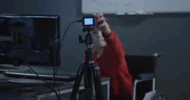 Boy in wheelchair recording a video for vlog