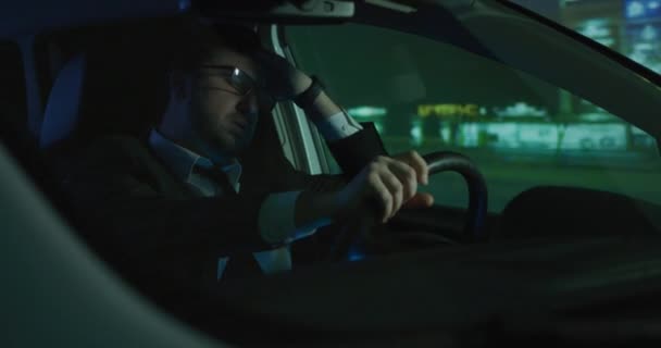 Sleepy man driving at night — Stockvideo