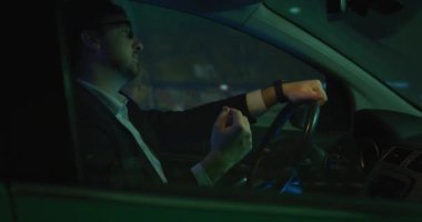 Man driving and gesturing to music