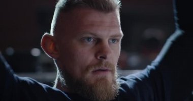 Young man lifting weight in gym