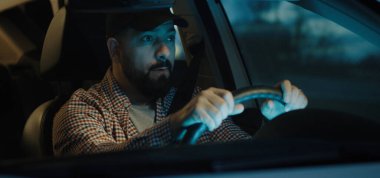 Sleepy man slapping himself while driving