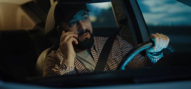 Man phoning while driving at night