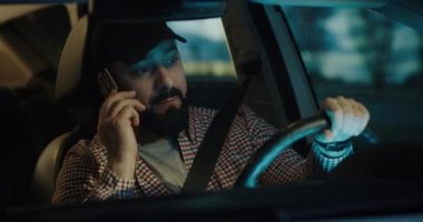 Man phoning while driving at night