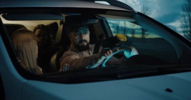 Man setting car GPS while driving