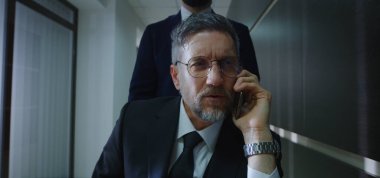 Tekerlekli sandalye yöneticisi ofis koridorundan arıyor.