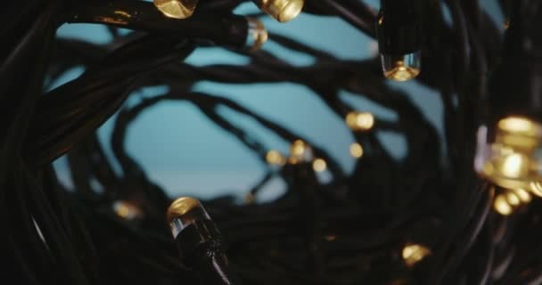 Fairy lights lying on tabletop — Stock Video