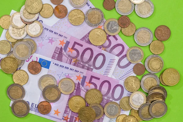 500 euro banknotes with coin on green