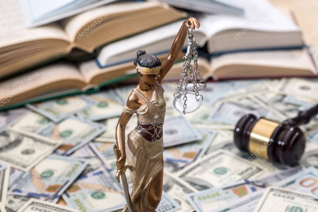 Lady justice or  themis, book and gavel on dollar bills